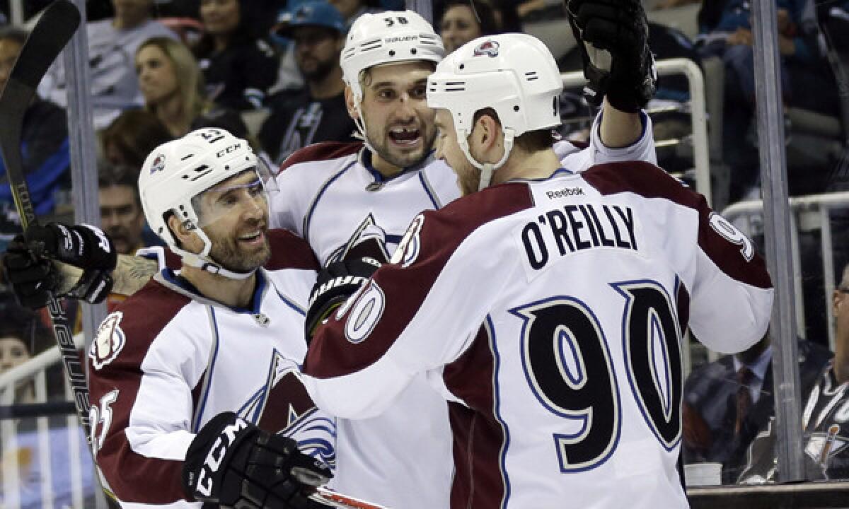 Colorado Avalanche forward Patrick Bordeleau, center, celebrates with teammates Maxime Talbot, left, and Ryan O'Reilly after scoring against the San Jose Sharks on Friday. Colorado has defied expectations in capturing the Central Division title.