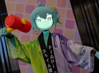 A HatsuMuv Cutieroid humanoid robot gestures.