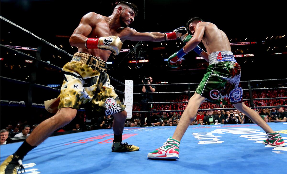 Leo Santa Cruz connects with a left jab against Abner Mares during their featerweight fight at Staples Center in August.