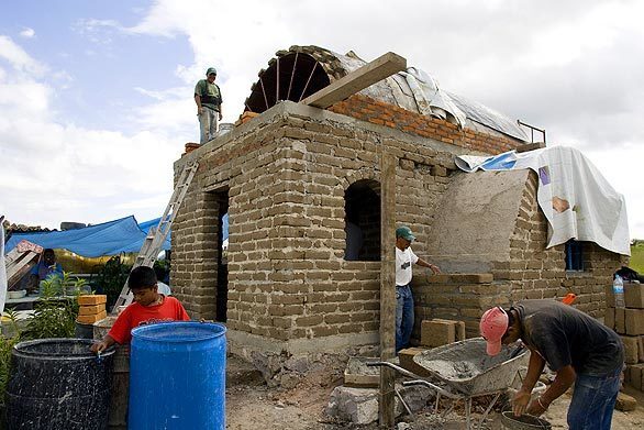 Volunteers work on an adobe house near San Miguel de Allende, Mexico. The homes are the work of Casita Linda, a small organization similar to Habitat for Humanity made up of foreign retirees. Their goal: to help the local poorest of the poor by "building hope, one house at a time."