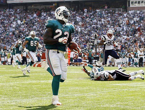 Dolphins running back Ronnie Brown runs for a 62-yard touchdown during the fourth quarter of their 38-13 win over the New England Patriots in Foxborough, Mass., on Sunday.
