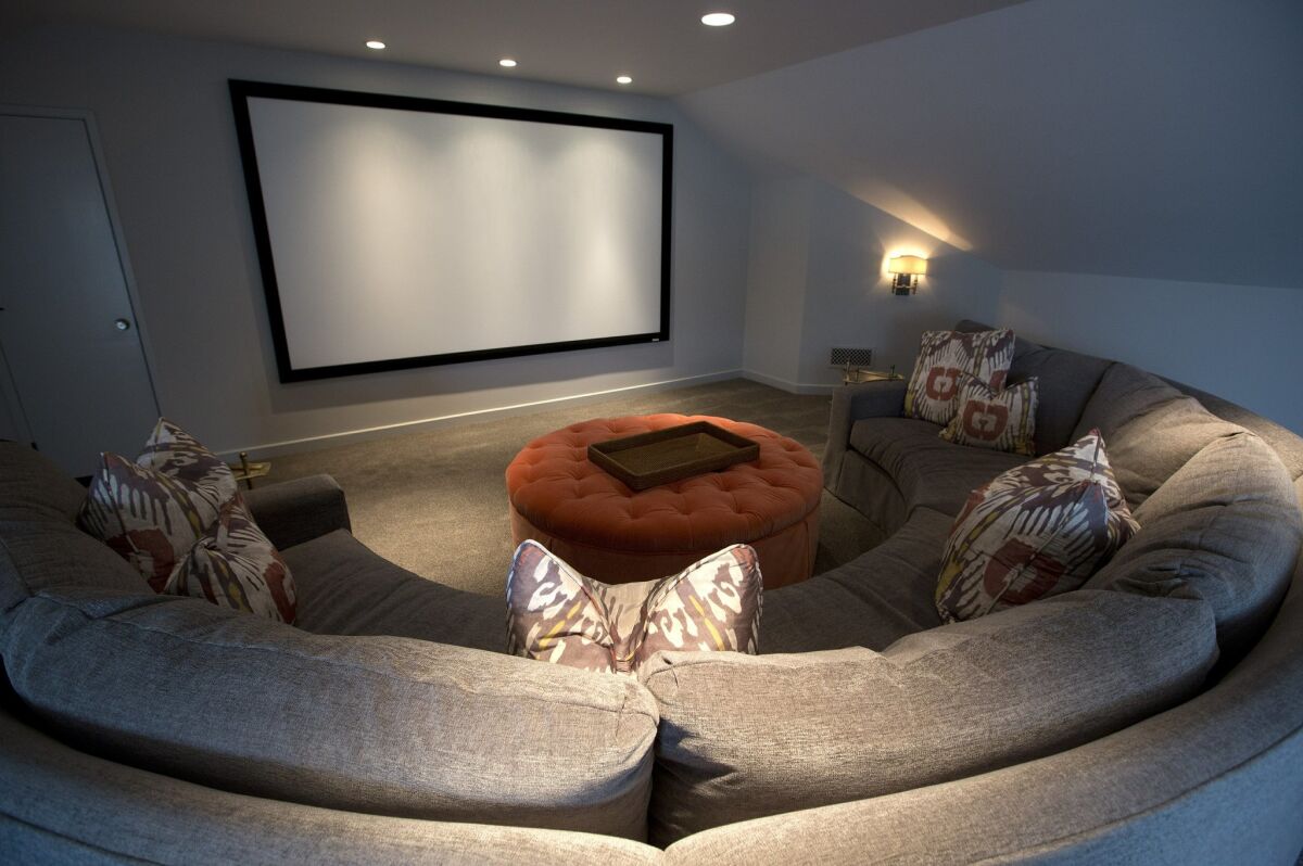 A media room with a giant TV projection screen was added to the third-floor attic area. — Earnie Grafton