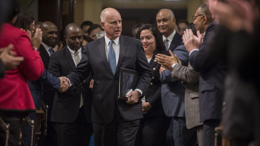 Gov. Jerry Brown is applauded by state legislators before delivering his final State of the State address in January. With the budge surplus soaring, the elected officials received pay raises Tuesday.