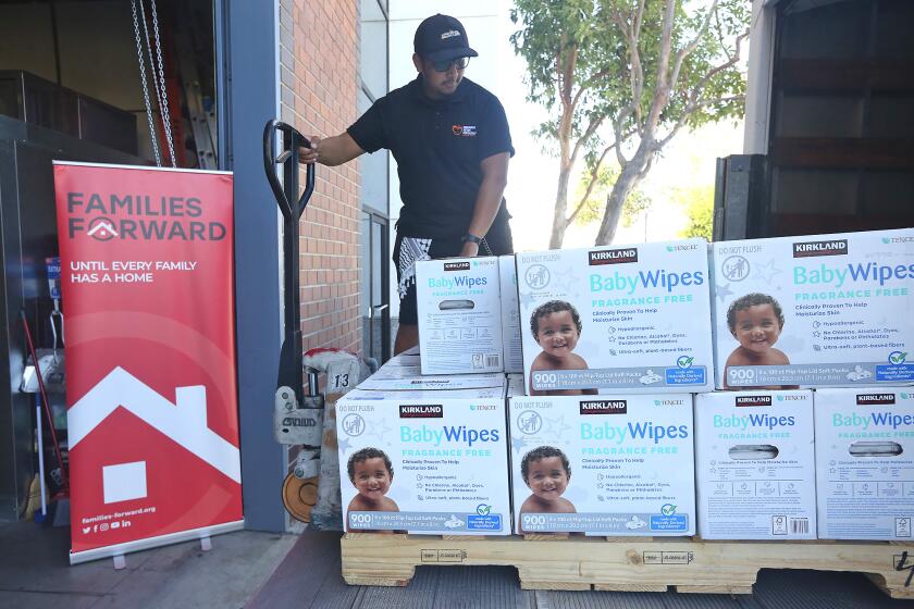 Driver Daniel Jimenez, delivers cases of baby products to the Families First facility after they secured over $2 million in funding to operate at full capacity for the next two years in Irvine.