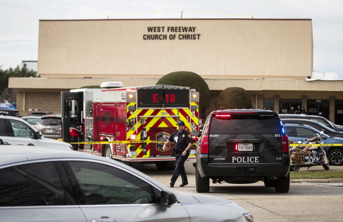 Police and fire personnel surround at the of the shooting at West Freeway Church of Christ in White Settlement, Texas, on Sunday.