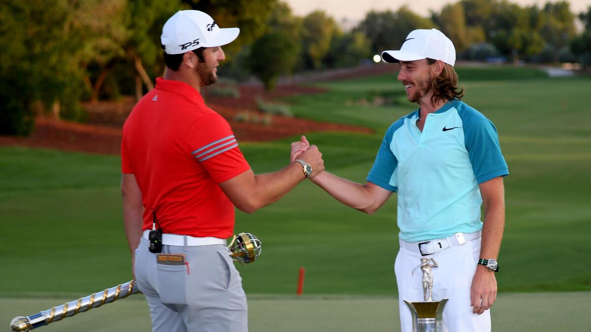 Tour Championship winner Jon Rahm, left, and Order of Merit winner Tommy Fleetwood congratulate one another on Sunday.