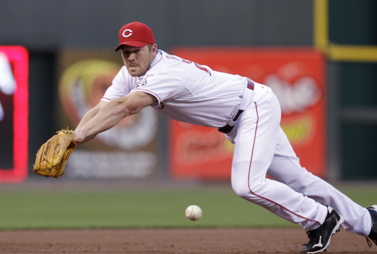 Cincinnati Reds third baseman Scott Rolen fields a ball hit by the Arizona Diamondbacks in 2010.
