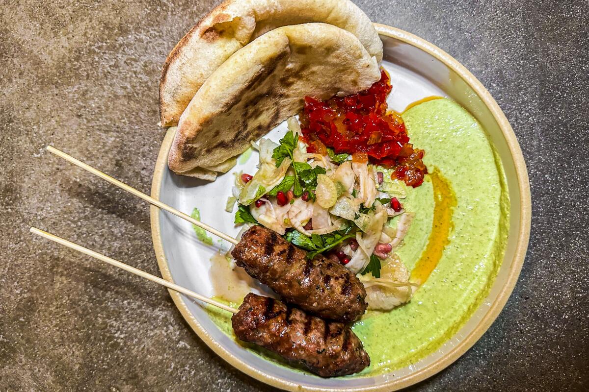 Lamb kefta and fresh-from-the-oven flatbread with zhoug labneh, pickled red pepper and onion jam and fennel salad.