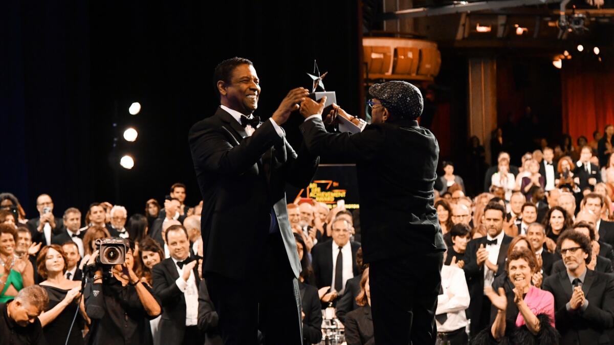 Spike Lee, right, presents the AFI Life Achievement Award to Denzel Washington at the Dolby Theatre on Thursday.