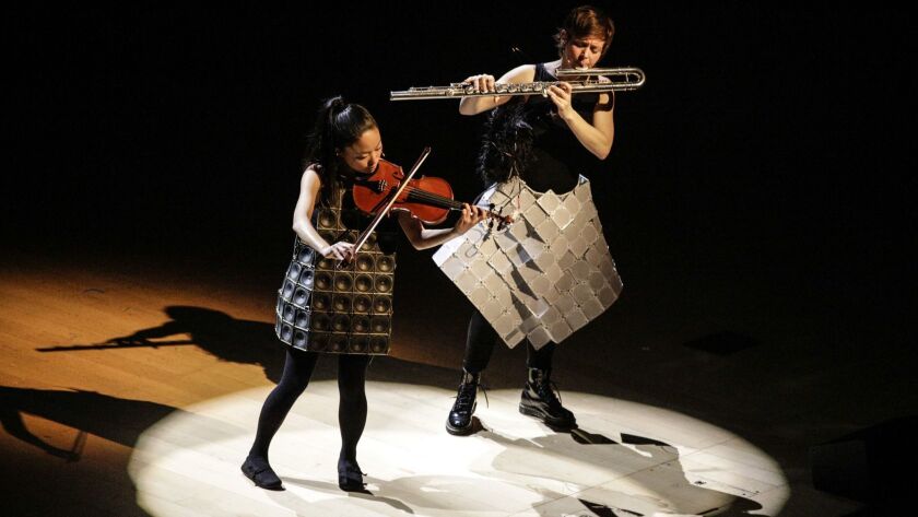 Pauchi Sasaki on violin and Claire Chase on flute perform Sasaki's "Gama XV: Piece for Two Speaker Dresses" as part of the concert Tuesday at Walt Disney Concert Hall.