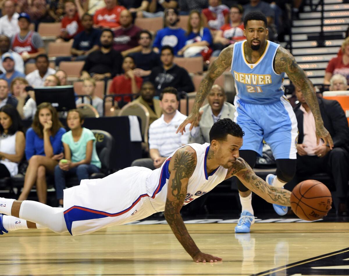 Clippers' Matt Barnes saves the ball from going out of bounds in front of Denver's Wilson Chandler on Oct. 18 in Las Vegas.