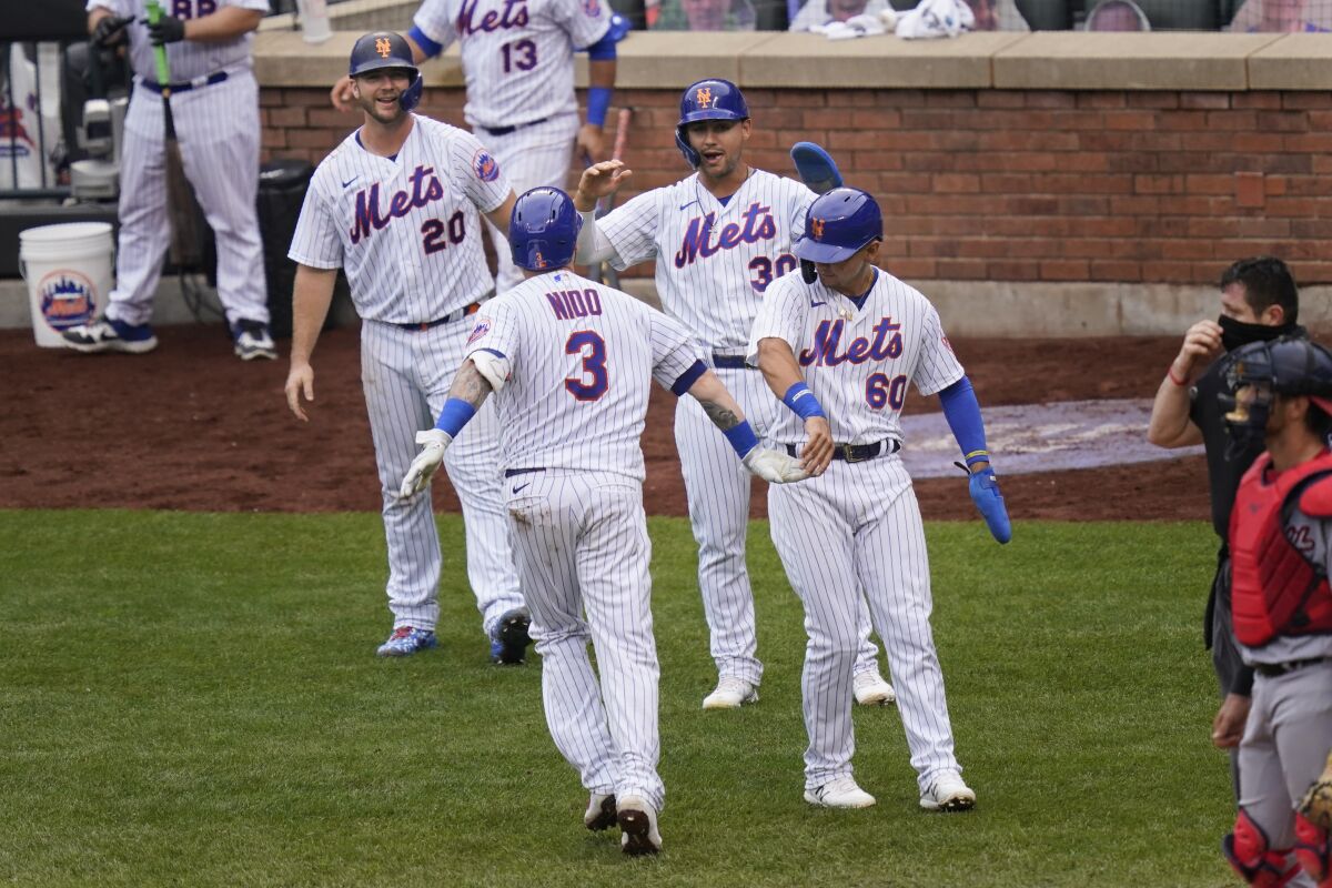 New York Mets' Tomás Nido (3) celebrates his grand slam with Pete Alonso, left, Michael Conforto, second from right, and Andres Gimenez during the fifth inning of a baseball game against the Washington Nationals at Citi Field, Thursday, Aug. 13, 2020, in New York. (AP Photo/Seth Wenig)
