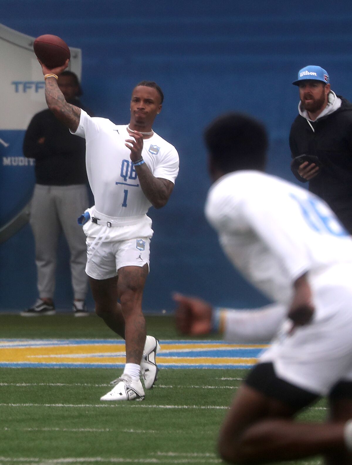Quarterback Dorian Thompson-Robinson throws to a cutting receiver during UCLA pro day. 
