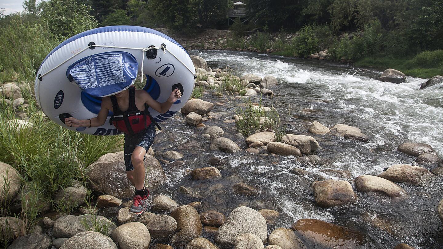 A rafter traverses rocks that are normally underwater as the drought-ridden Kern River flows toward Lake Isabella.