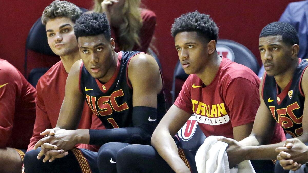 USC players watch the action during an 86-64 loss to Utah on Thursday.