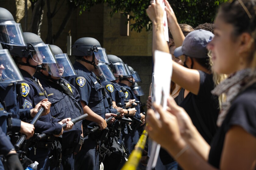 Protestors march to the San Diego Police Department