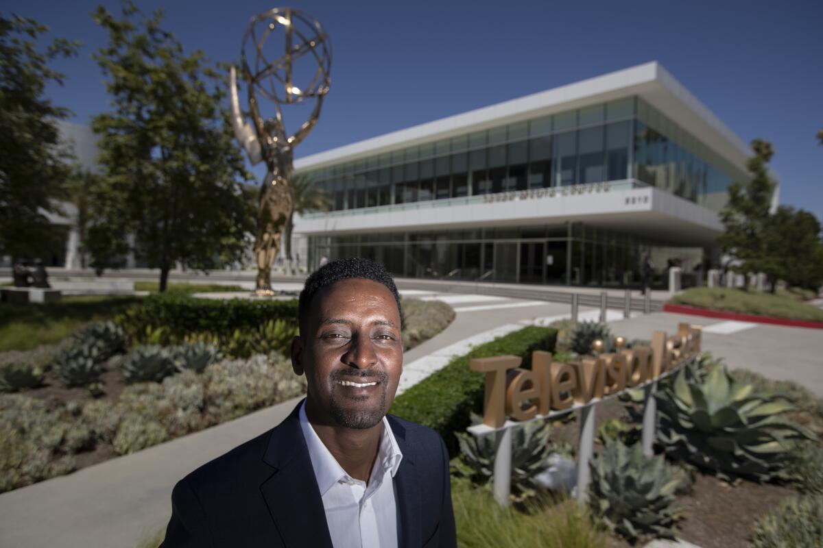 Hussen in front of an Emmy statue outside the Television Academy offices in North Hollywood.