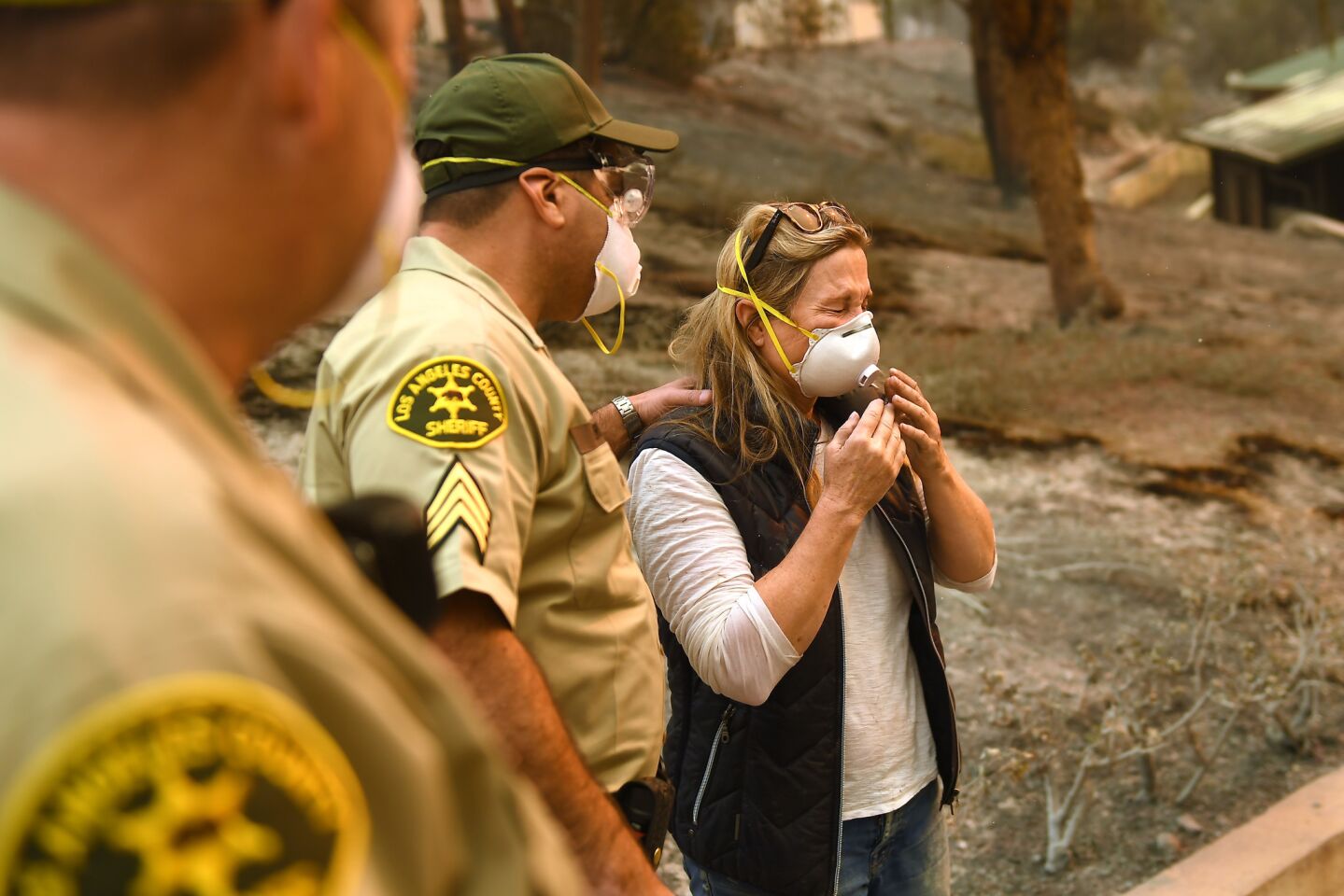 Anne Marie Mueller is notified by L.A. County Sheriff's Officer Ernie Ferreras that her friends in Malibu are safe.