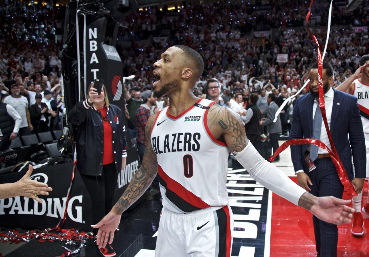 Trail Blazers guard Damian Lillard celebrates after making the game-winning shot to eliminate the Thunder in Game 5 of their playoff series on April 23.