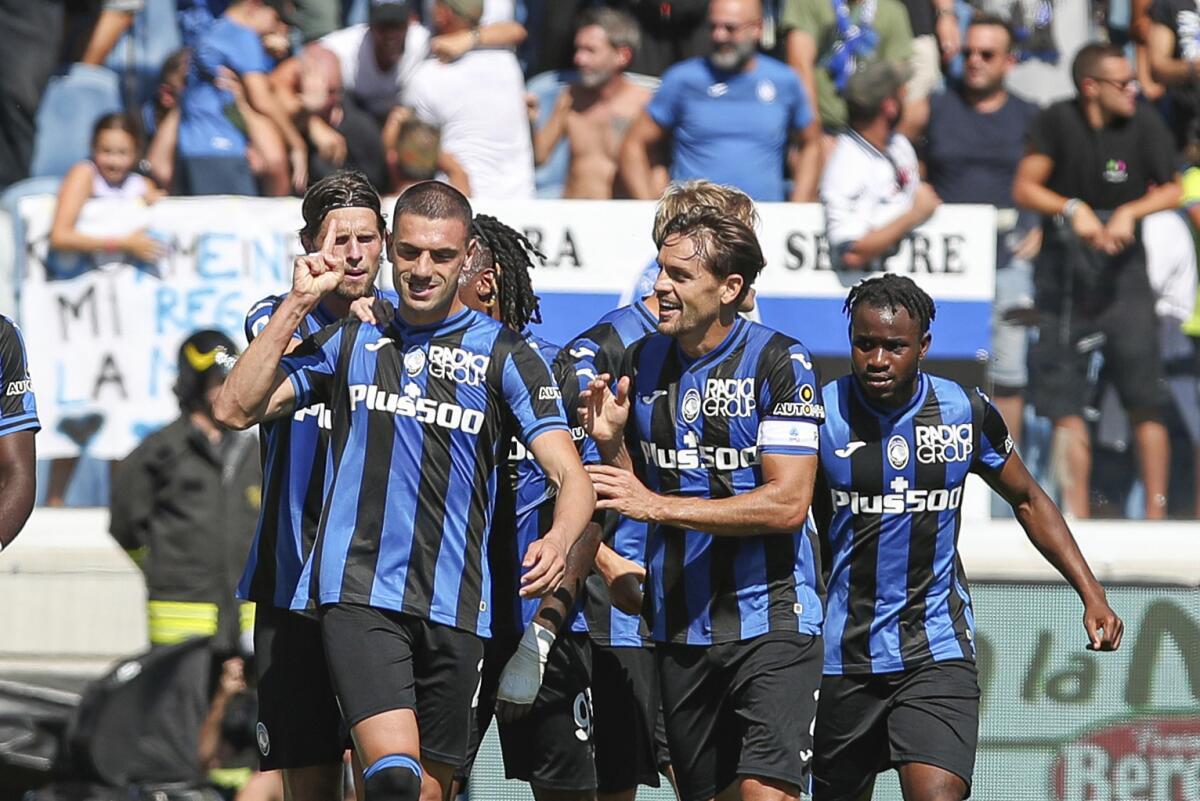 Atalanta's Merih Demiral, left, celebrates with teammates after scoring celebrates with teammates after scoring his side's first goal during the Italian Serie A soccer match between Atalanta and Cremonese, at the Gewiss Stadium in Bergamo, Italy, Sunday, Sept. 11, 2022. (StefanoNicoli/LaPresse via AP)
