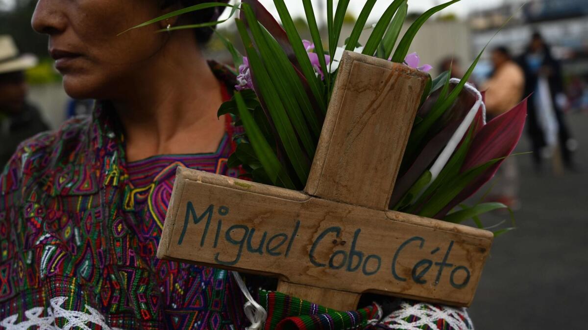 Family members of those killed march in Guatemala City.