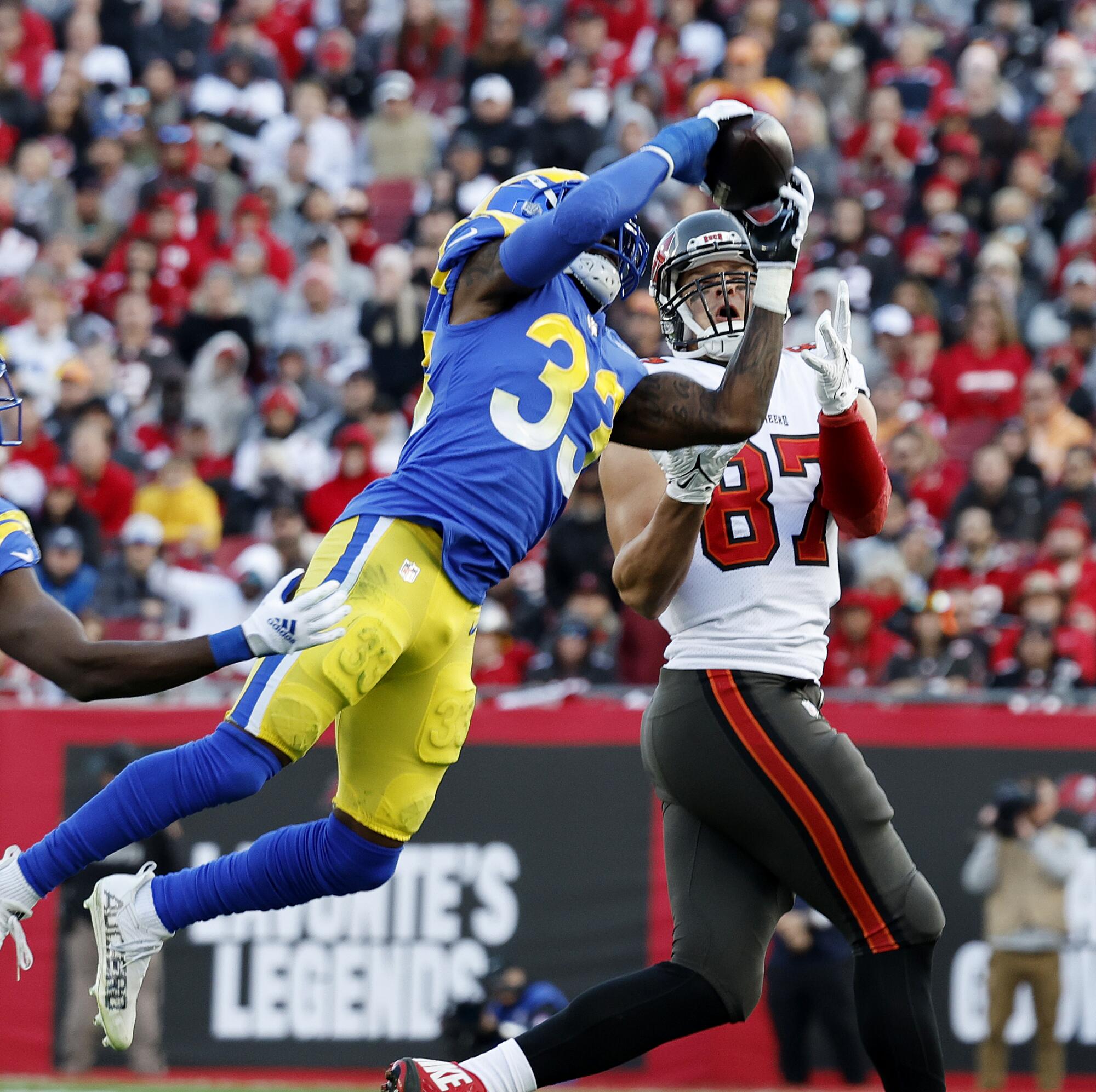 Rams safety Nick Scott, left, intercepts a pass intended for Tampa Bay Buccaneers tight end Rob Gronkowski.
