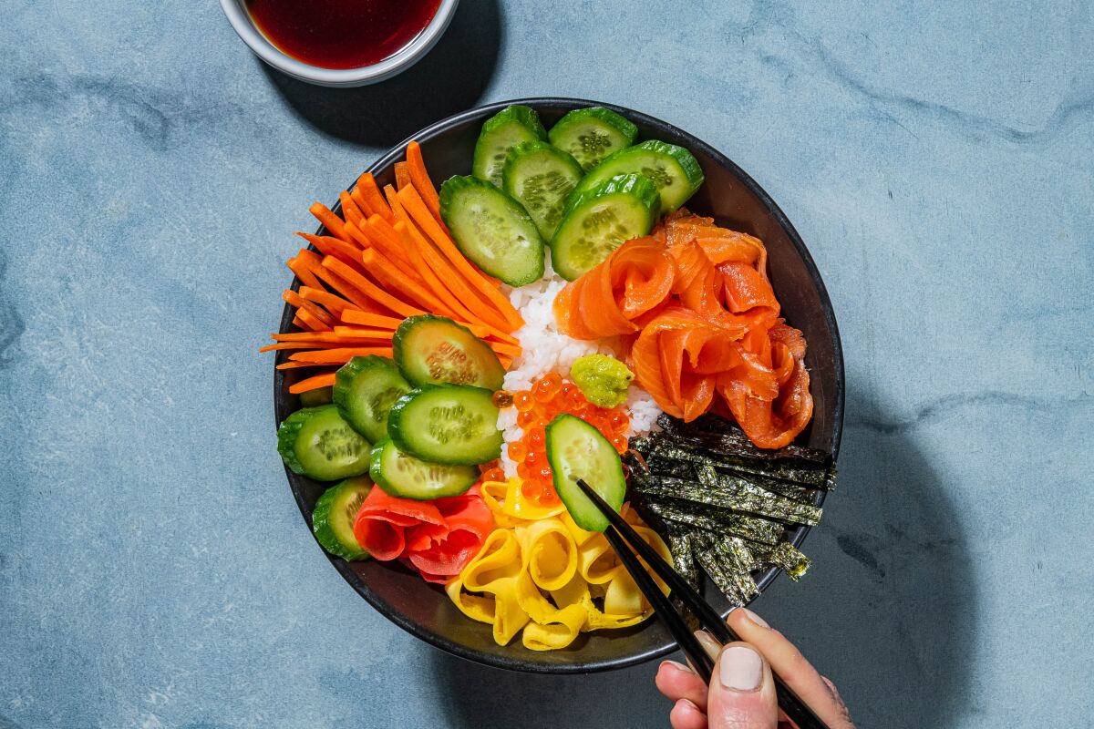 A bowl of chirashi sushi, has a variety of color groups to create visual interest.