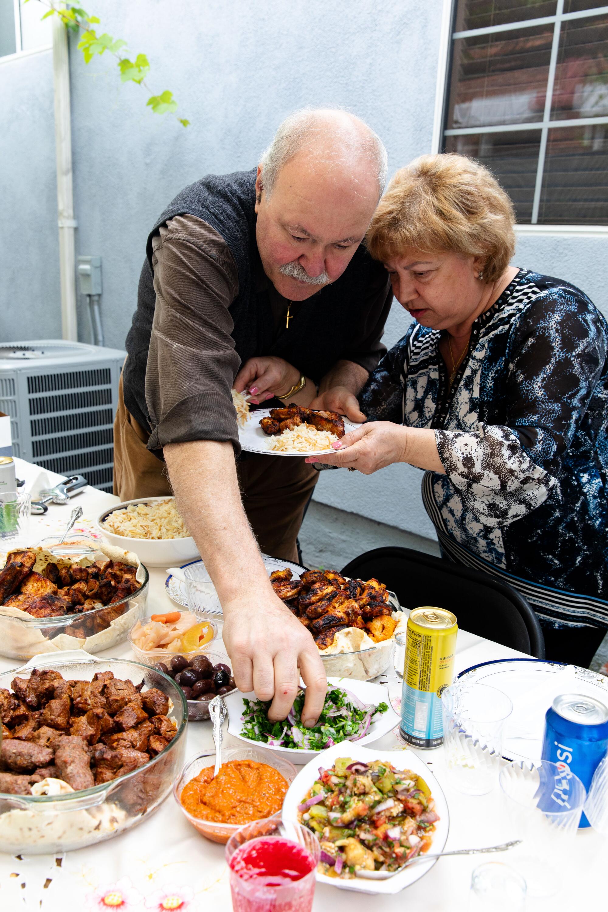 Alex Khachoyan and his wife, Tina, prepare a feast in their backyard.