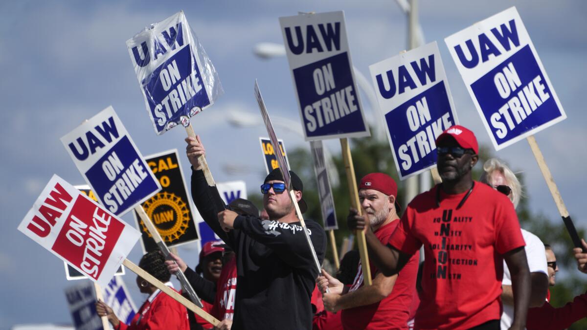 Union members hold up strike signs