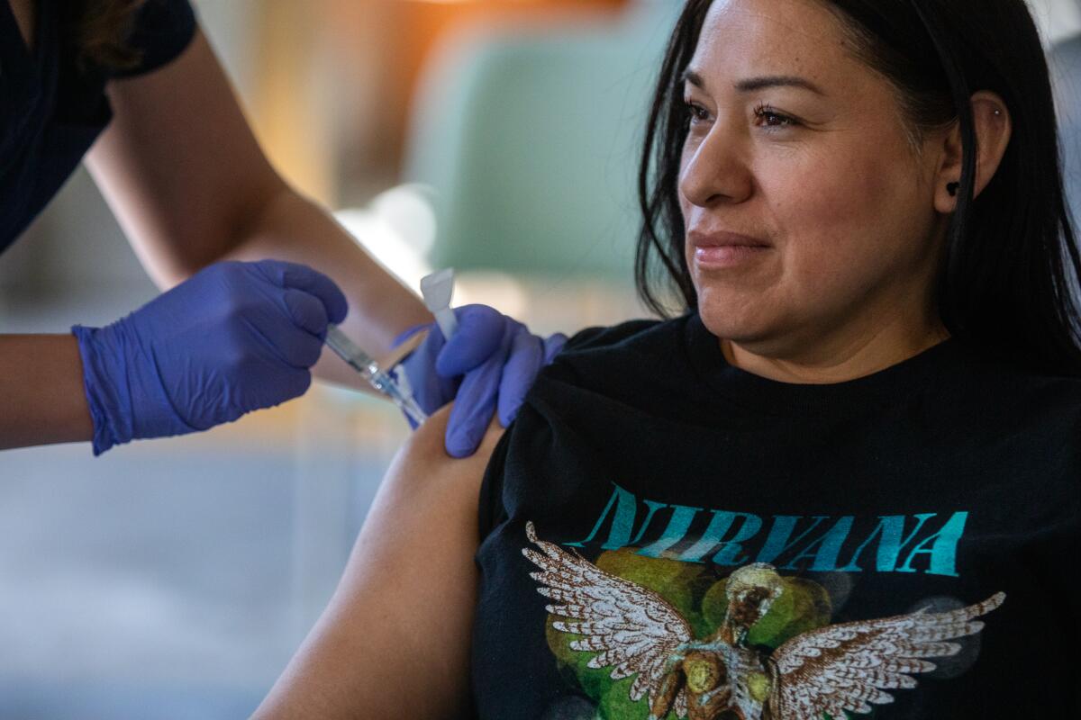 Pasadena, CA - October 12: Liliana Ramos, 43, of Los Angeles, receives a vaccine at a flu and COVID vaccination clinic Kaiser Permanente Pasadena on Thursday, Oct. 12, 2023, in Pasadena, CA. (Francine Orr / Los Angeles Times)