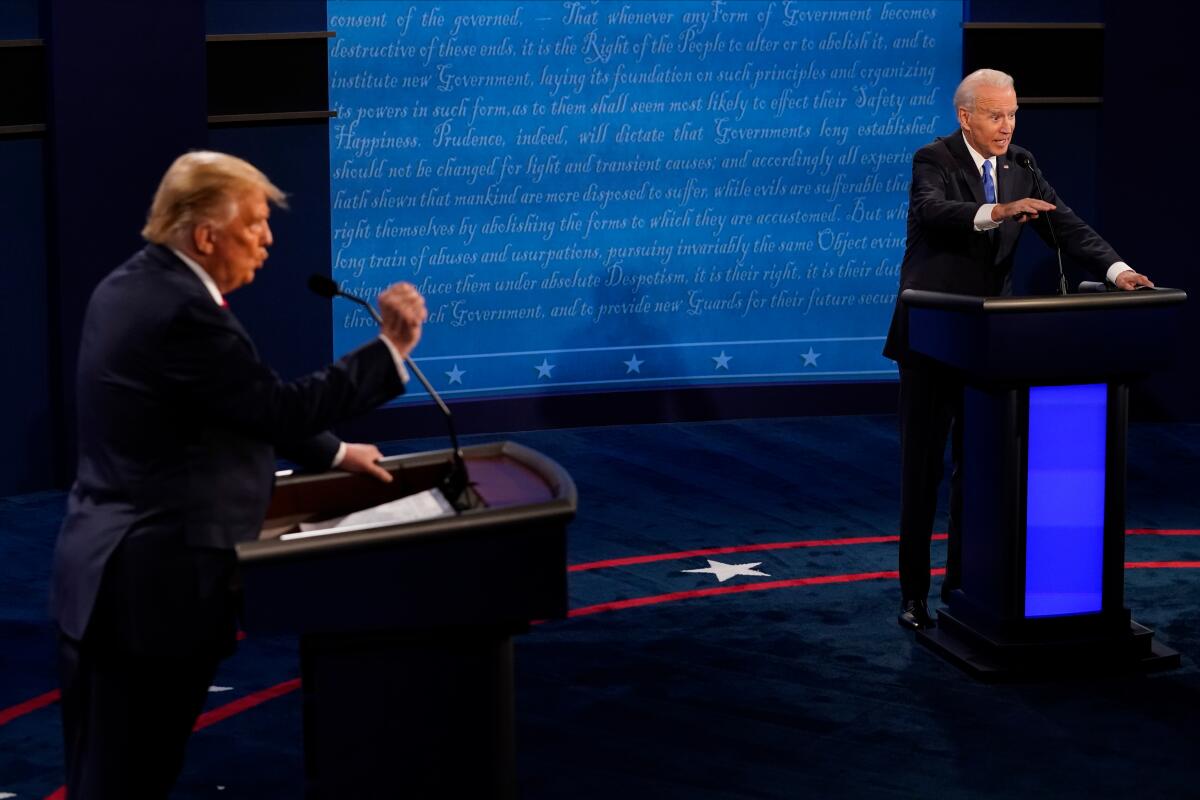 Joe Biden answers a question as Donald Trump gestures in a presidential debate during the last election cycle.