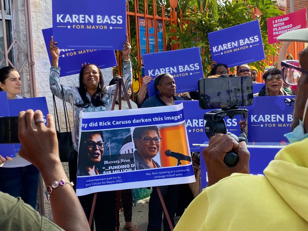 A sign with the two images displayed at a small rally