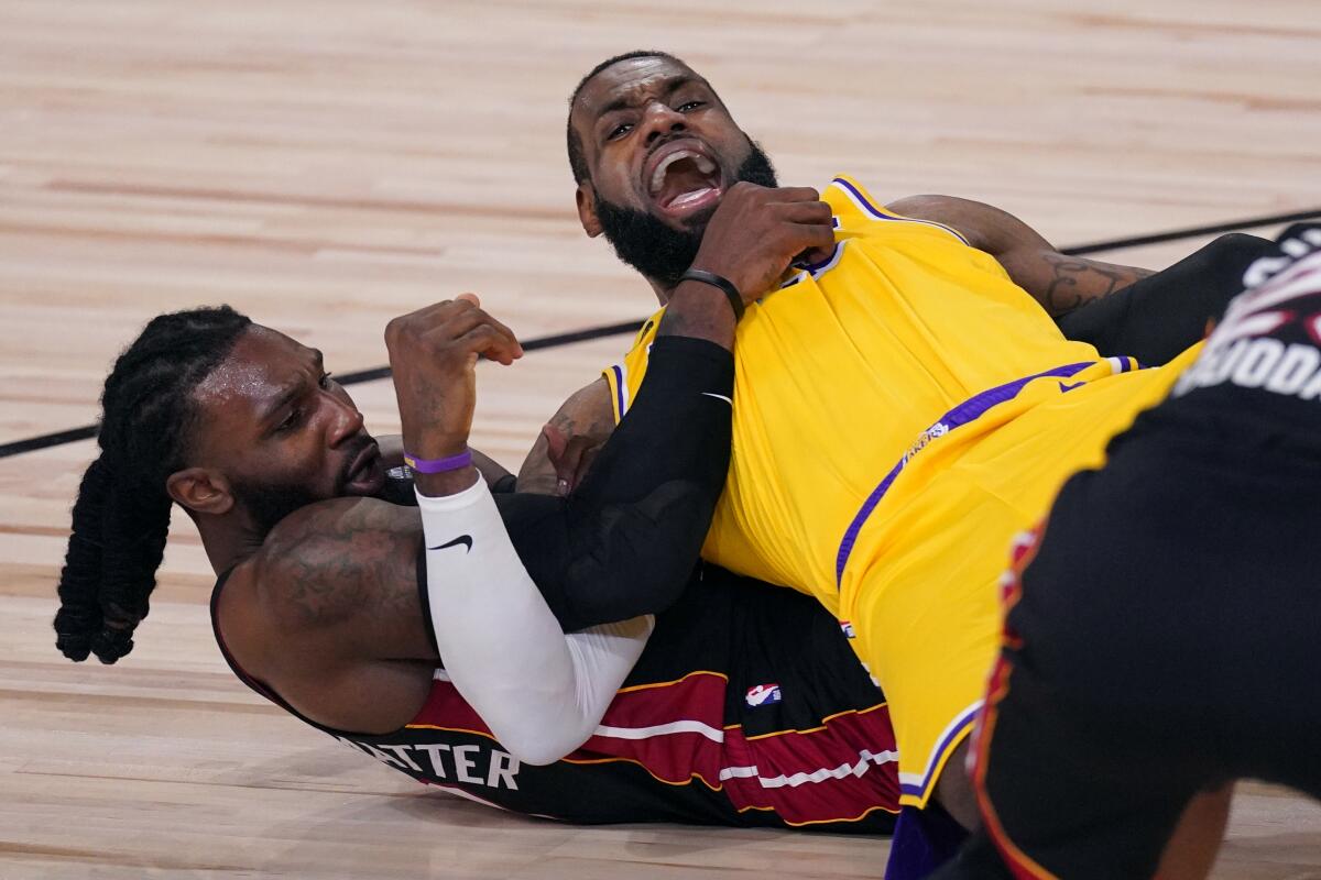 Lakers forward LeBron James gets tangled with Miami forward Jae Crowder during the first half of Game 1.