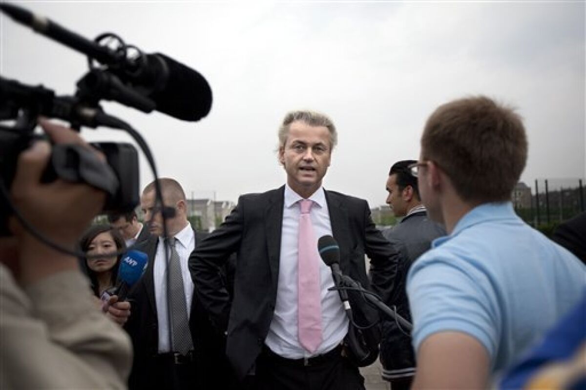 Populist anti-Islam leader Geert Wilders, center, during an interview prior to casting his ballot, in The Hague, Netherlands, Wednesday June 9, 2010. Polls opened Wednesday in the Netherlands where Dutch voters will elect a new parliament after an election campaign focused on economic and immigration policy. The conservative VVD party and its leader Mark Rutte are leading in opinion surveys on a deficit-busting, tough-on-immigration platform. The anti-Islam Freedom Party and its leader Geert Wilders also hope to book large gains. (AP Photo/Cynthia Boll)