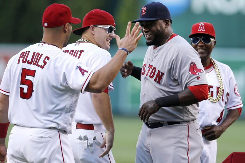 Boston Red Sox's David Ortiz, second from right, is greeted on the mound by Angels' Albert Pujols, left, and Mike Trout, second left, and infield coach Alfredo Griffin before Thursday's game at Angel Stadium.