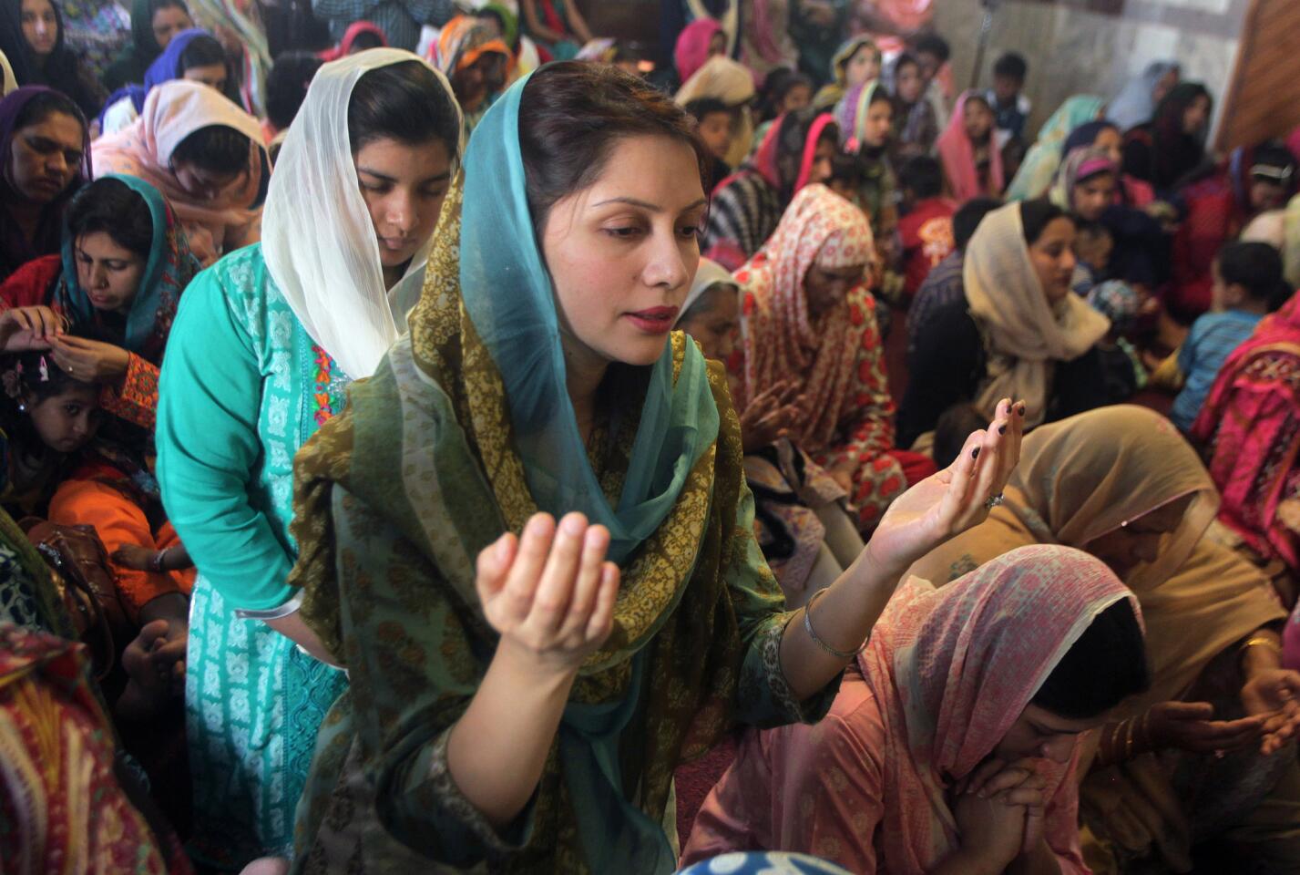 Christian women pray during an Easter service at St. Anthony's Church in Lahore, Pakistan.