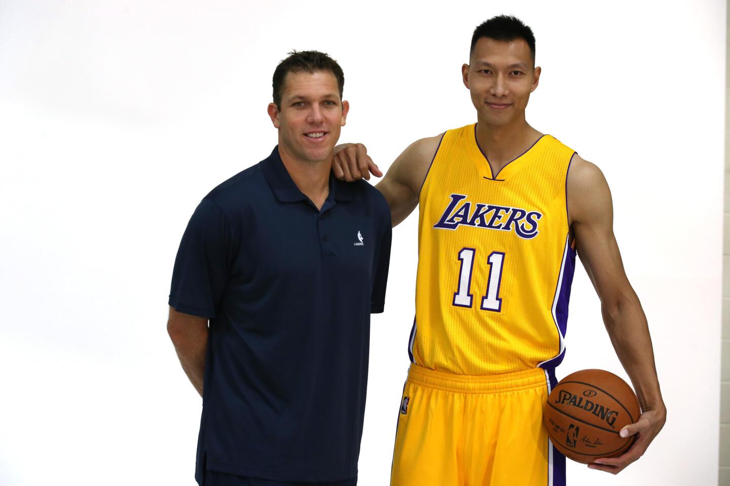 Lakers Coach Luke Walton and center Yi Jianlian pose for pictures during the team's media day.