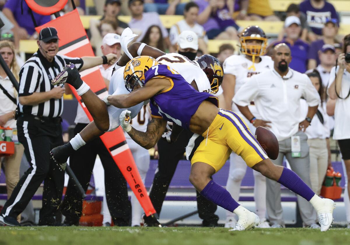 LSU cornerback Derek Stingley Jr. (7) forces a fumble by Central Michigan running back Darius Bracy (2) during the first quarter of an NCAA college football game in Baton Rouge, La,. Saturday, Sept. 18, 2021. (AP Photo/Derick Hingle)