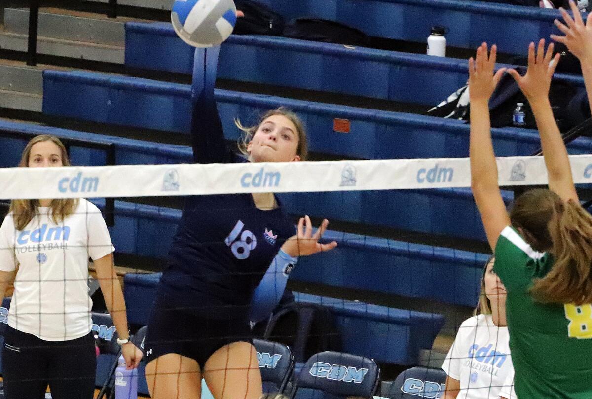 Corona del Mar's Sofia Dajnowiec (18) goes up for a kill against Edison on Wednesday.