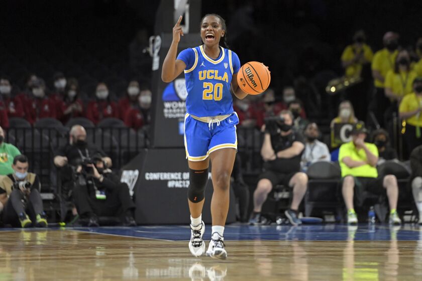 UCLA guard Charisma Osborne brings the ball up during the team's NCAA college basketball game on March 3, 2022.