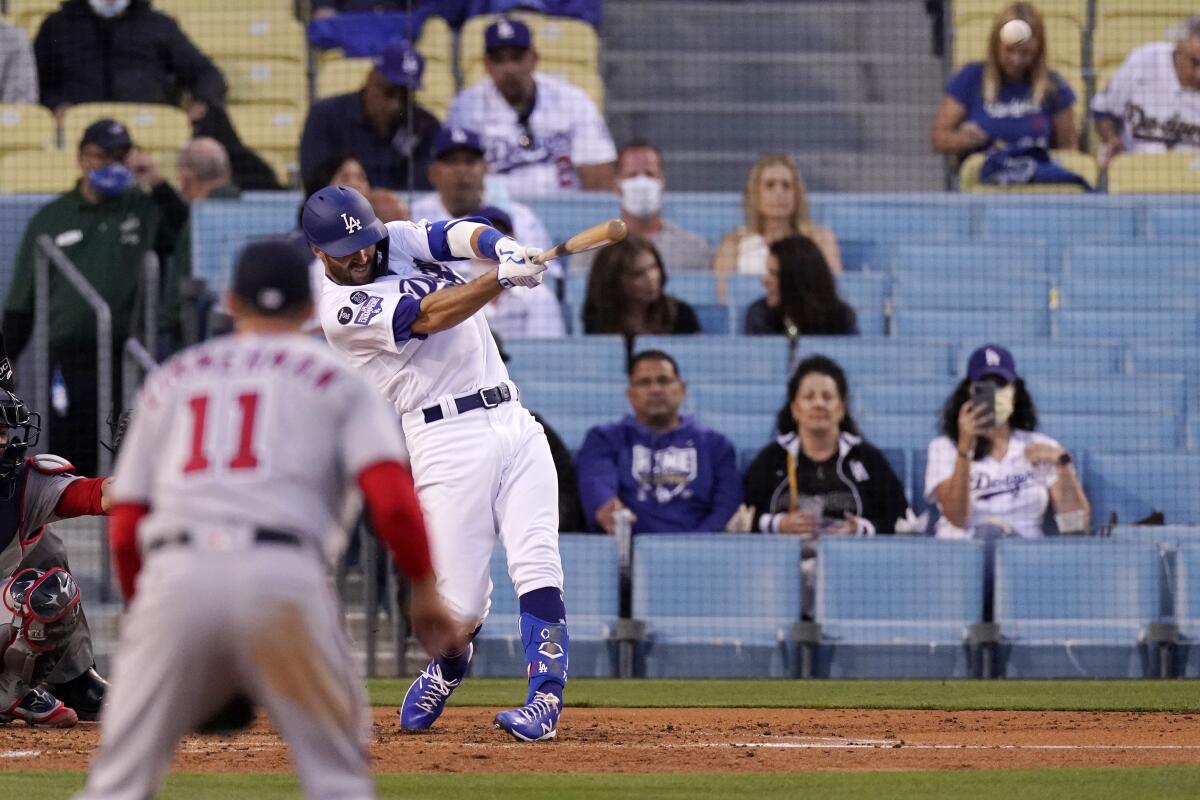 Dodgers center fielder Chris Taylor hits a three-run home run during the second inning of a 9-5 win.