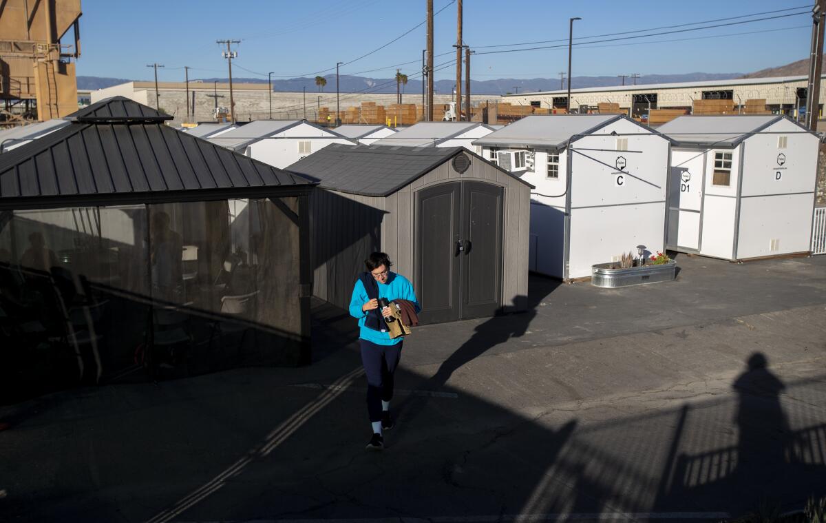 A resident of the tiny home village in Riverside walks to the common shower area. 