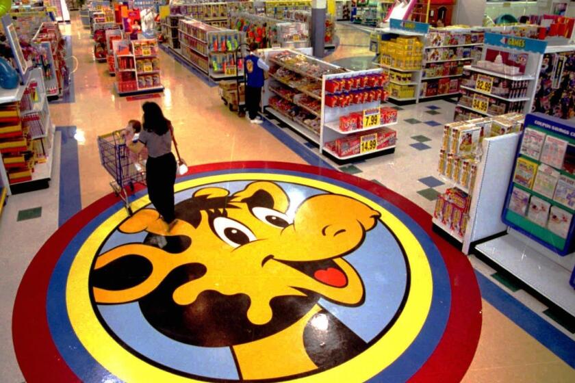 alled bz0814toys 8.31 x 5.75 inches ADV. FOR USE ANYTIME--A woman pushes a shopping cart over a floor decal of Toys R Us mascot Geoffrey the giraffe at the remodeled Toys R Us store in Raritan, N.J. July 31, 1996. The company has come up with a new format for its stores, hoping to make them more interesting and easier for shoppers. (AP Photo/Daniel Hulshizer) 8/14/96 F1c