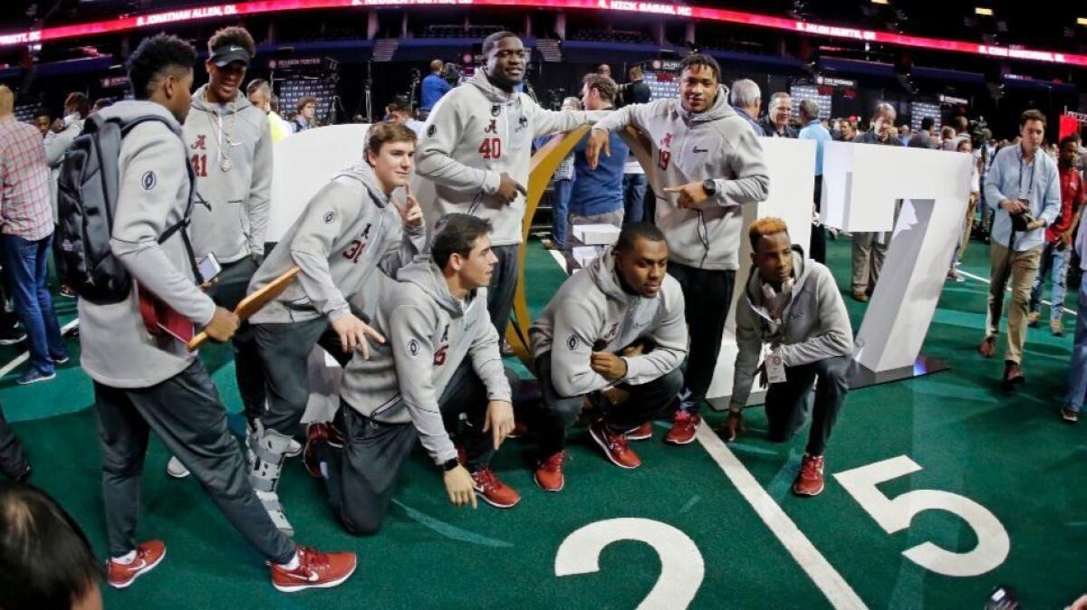 Alabama players have a little fun with photographers during media day on Saturday. Alabama faces Clemson on Monday in the College Football Playoff championship game.