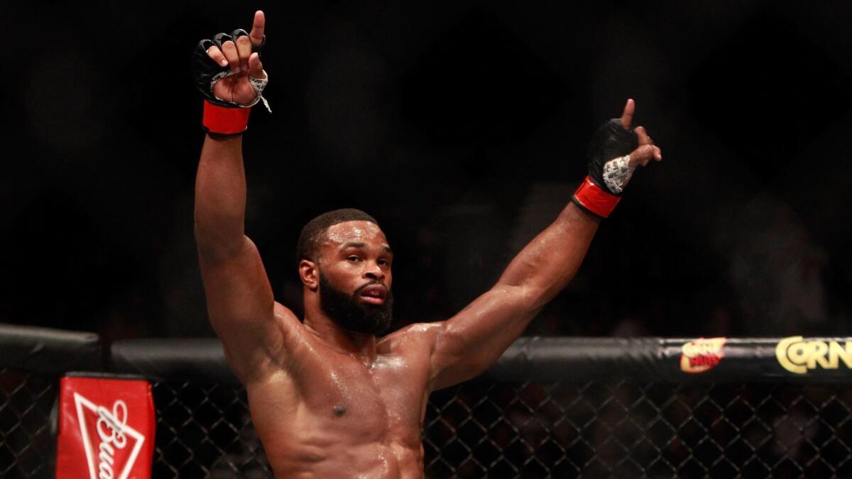 Tyron Woodley raises his arms after three rounds against Kelvin Gastelum on Jan, 31, 2015, in Las Vegas.