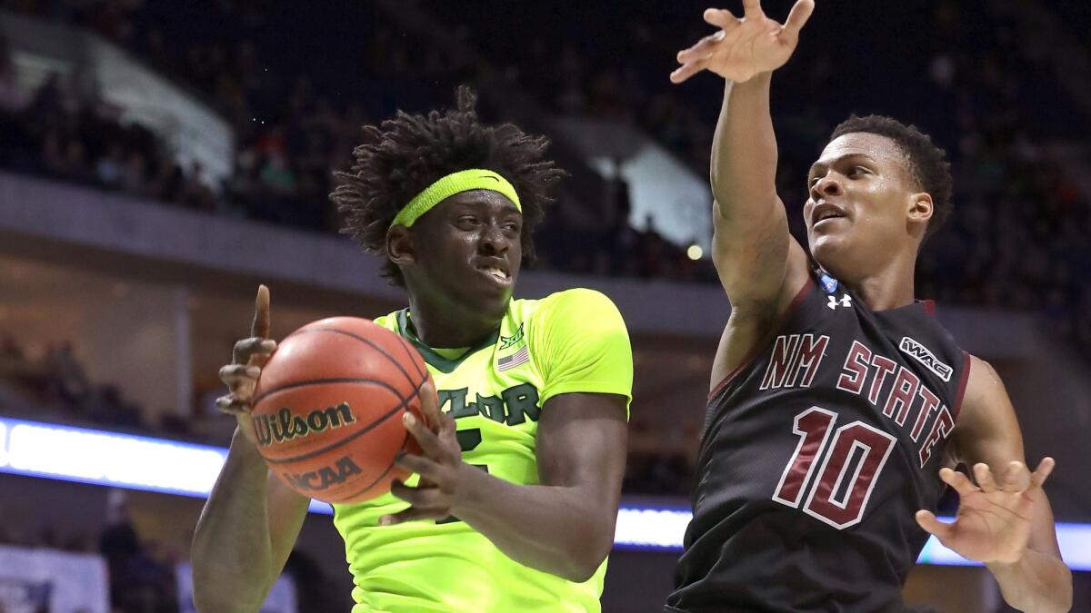 Baylor forward Johnathan Motley tries to power his way to the basket against New Mexico State's Jemerrio Jones during the second half of their first-round NCAA tournament game Friday.