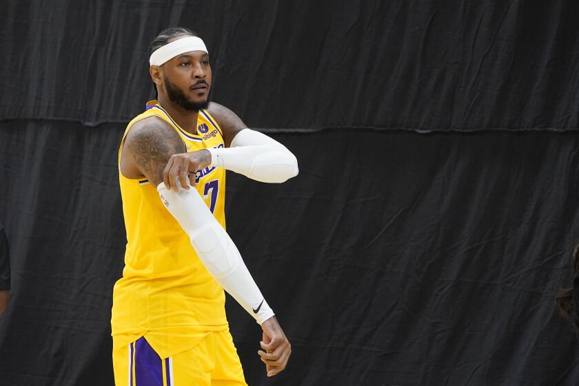 Los Angeles Lakers forward Carmelo Anthony walks on the court during the NBA basketball team's Media Day Tuesday, Sept. 28, 2021, in El Segundo, Calif. (AP Photo/Marcio Jose Sanchez)
