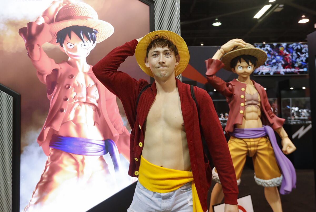 Kerry Schinkel play acts as comic book characters, Monkey D. Luffy or "Straw Hat," at Wondercon 2023.
