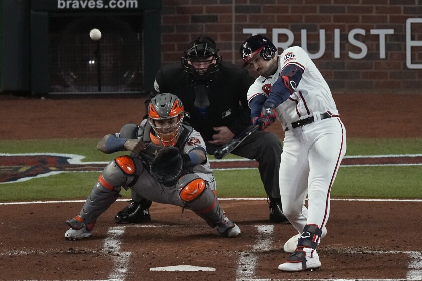 FILE - Atlanta Braves' Adam Duvall hits a grand slam home run during the first inning in Game 5 of baseball's World Series between the Houston Astros and the Atlanta Braves Sunday, Oct. 31, 2021, in Atlanta. The Atlanta Braves tendered a contract to slugger Adam Duvall, ensuring the National League RBI leader returns to the World Series-winning club for another season. The tendering of Duvall by the Tuesday night, Nov. 30, deadline was among a flurry of moves for the Braves. (AP Photo/John Bazemore, File)