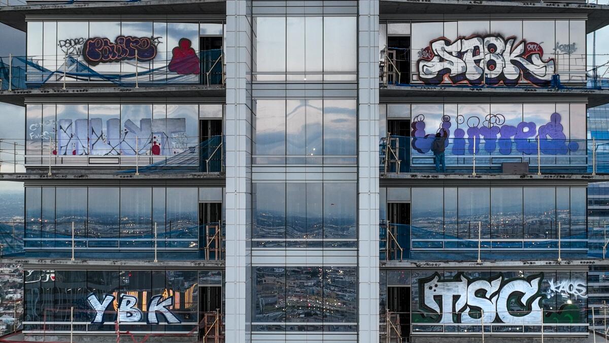 Taggers graffitied more than 25 stories of an unfinished downtown L.A.  skyscraper that's been sitting dormant for years. 